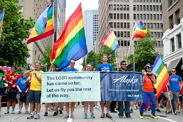Alaska Airline LGBT community marching in pride parade.