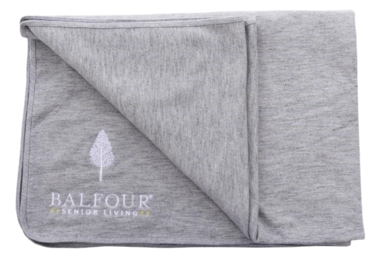 Marine layer blanket embroidered with Balfour Senior Living logo.