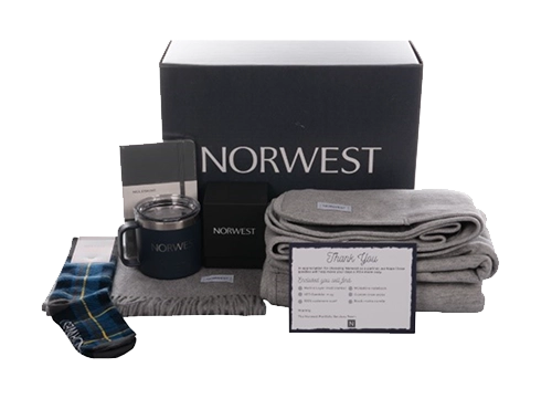 Norwest Venture box kit with insulated mugs, socks, and fleece blanket.