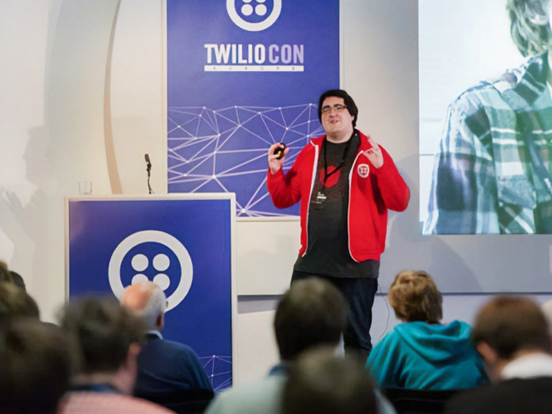 Twilio rep hosting their conference with custom designed banner and podium.